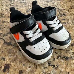 Nike Kids Black and White Sneakers with Orange Swoosh